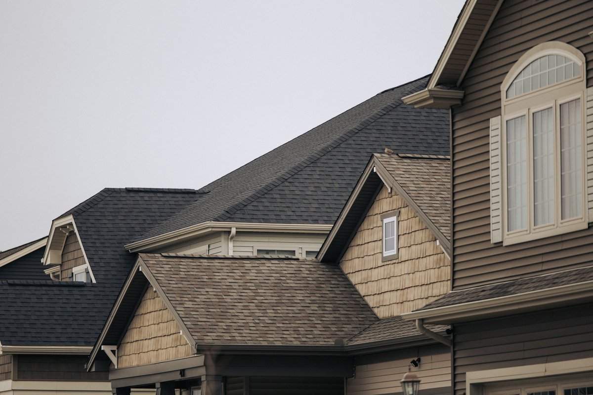 A row of houses with shingle roofs